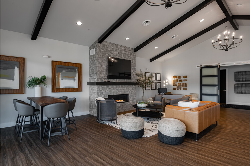 a living room with a fireplace and a table and chairs