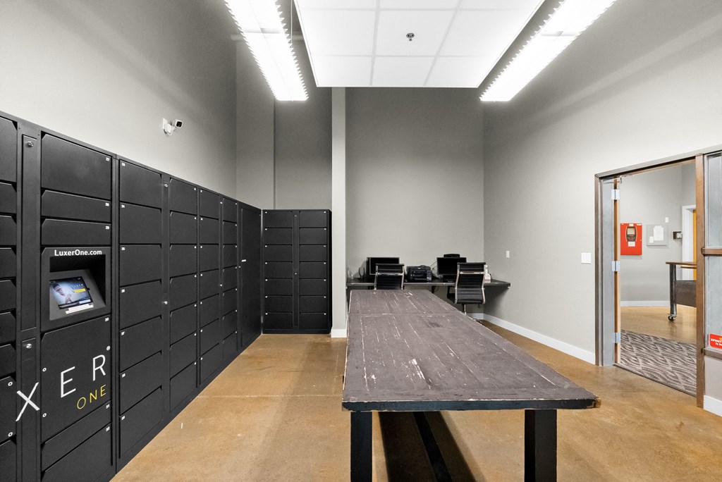 A conference room with a long table and chairs, and a wall of lockers with the word "XERO" on them.