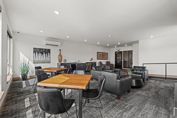 A conference room with a long table surrounded by chairs.