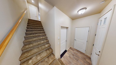 the landing of a staircase in a home with white doors