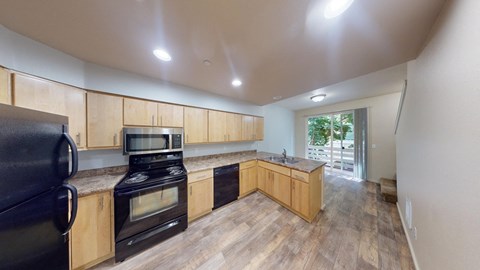 a kitchen with wooden cabinets and black appliances