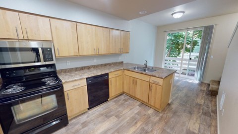 a kitchen with wooden cabinets and stainless steel appliances