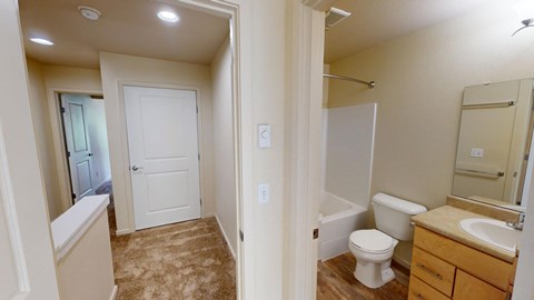 a bathroom with a toilet and a sink and a shower