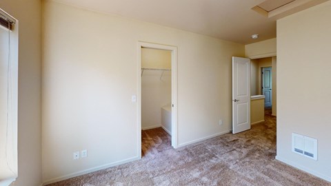 a bedroom with a closet and a door to a bathroom