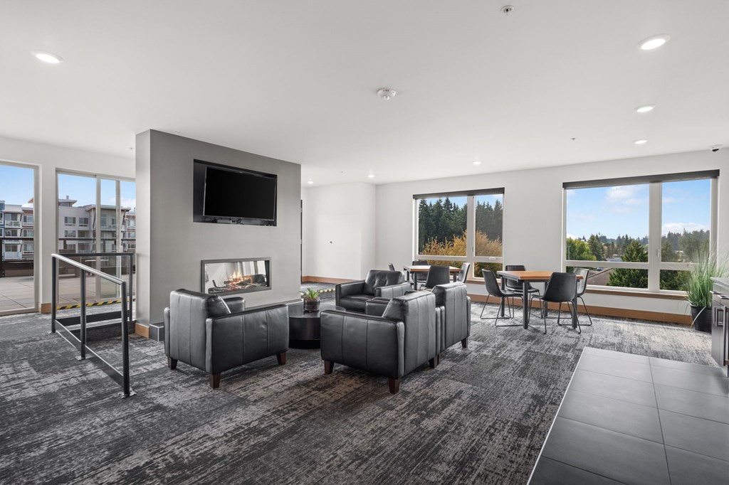 A modern living room with grey furniture and a flat screen TV.