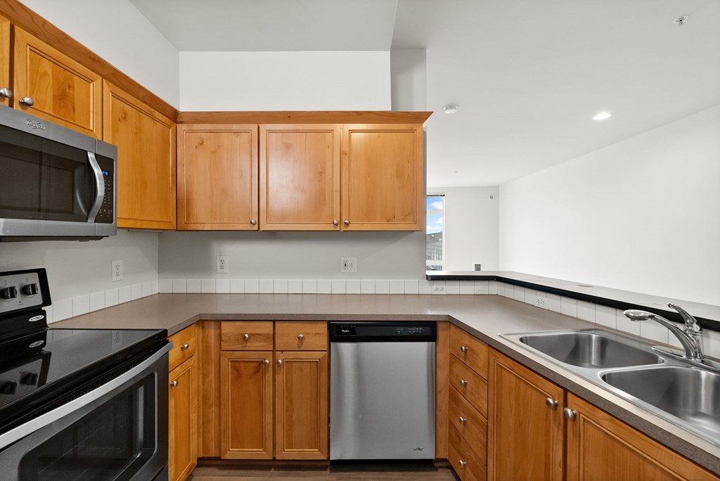A kitchen with wooden cabinets and stainless steel appliances.
