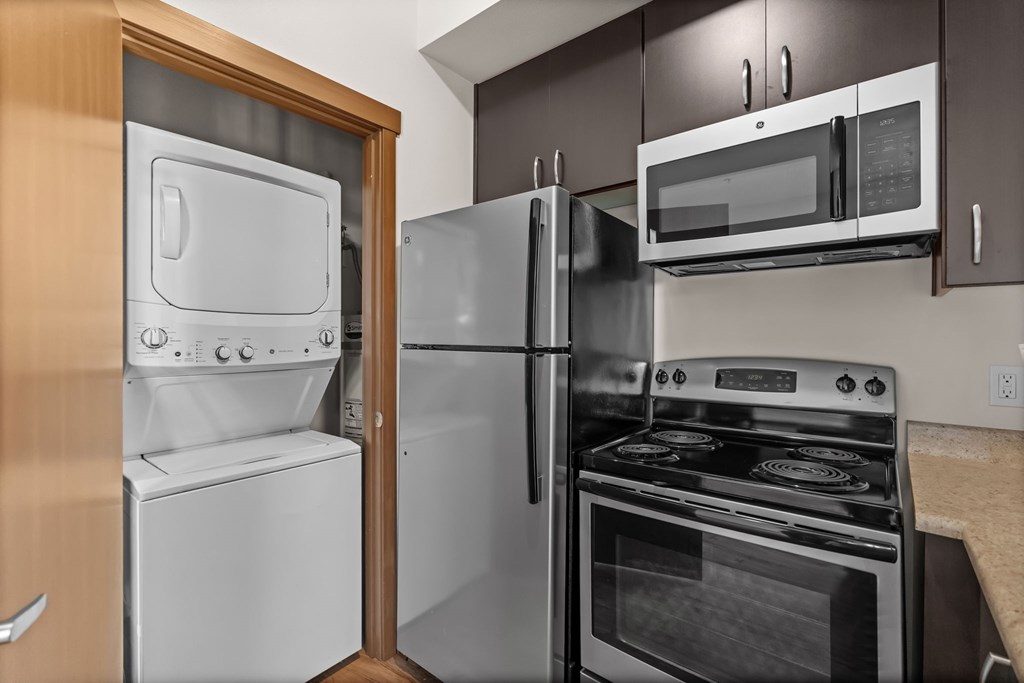 A modern kitchen with a white oven and microwave.