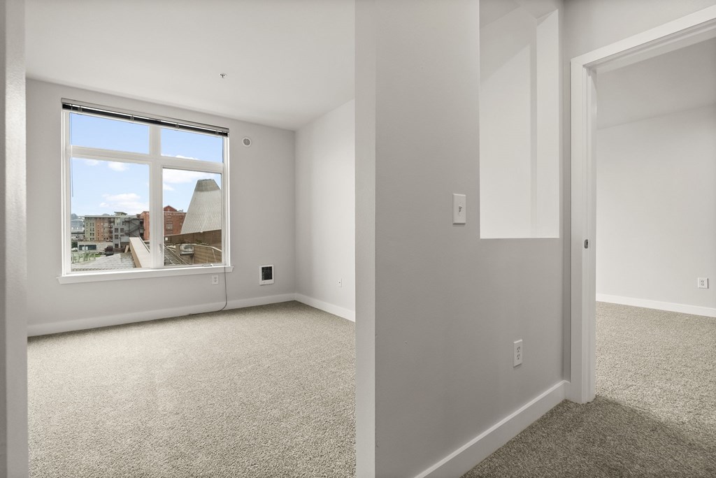 A room with a window overlooking a cityscape.