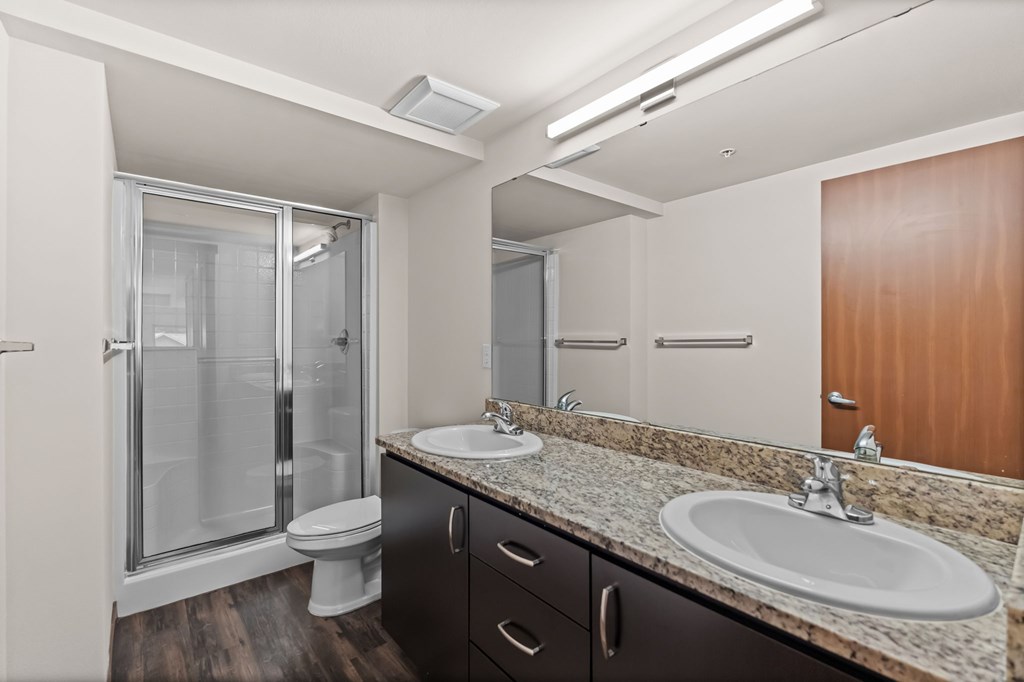 A bathroom with a sink, toilet, and shower.