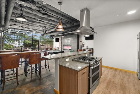 a large kitchen and dining area with stainless steel appliances and counter tops