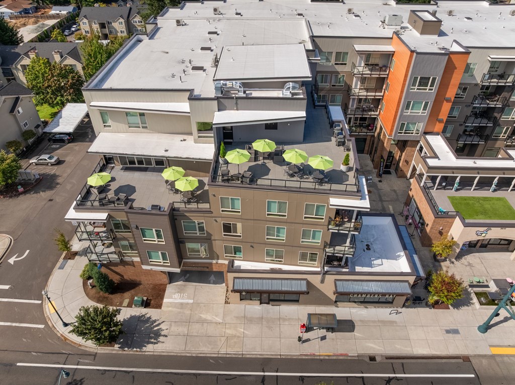 A large building with a green lawn in front.