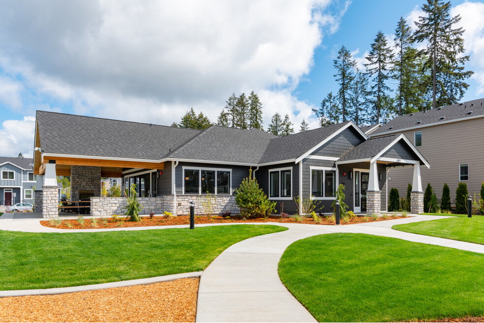 a house with a yard and a sidewalk in front of it