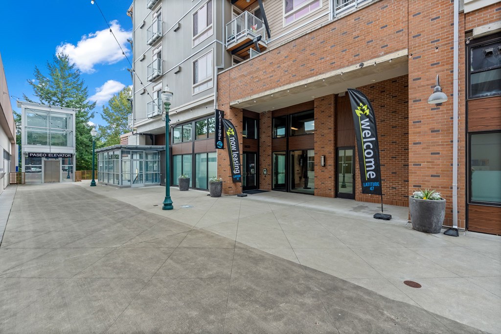 A building with a black and white sign that says "Welcome".