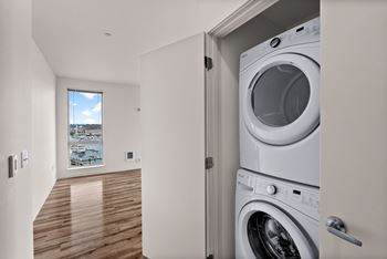 A washing machine is in a doorway.
