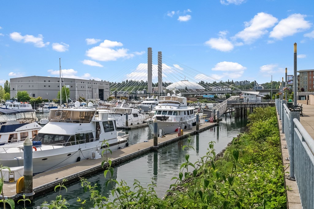 A marina with boats docked and a building in the background.