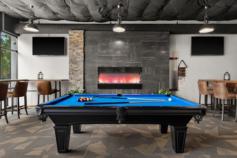 a games room with a pool table and a fireplace