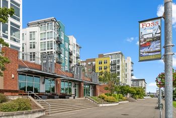 A building with a sign that says "FOSS" on a pole.