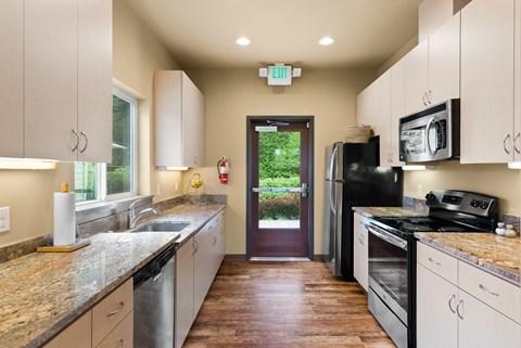 a kitchen with granite counter tops and stainless steel appliances