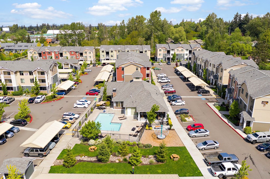 an aerial view of a neighborhood with houses and swimming pools