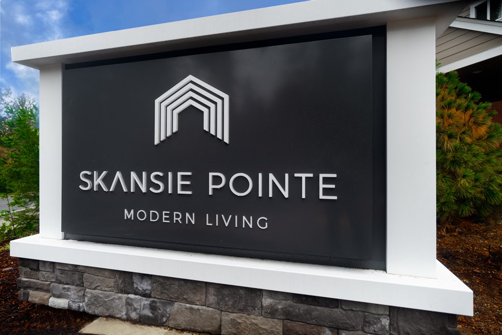 a sign for skaneate pointe in front of a building
