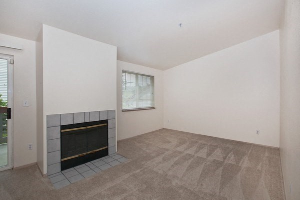 an empty living room with a fireplace
