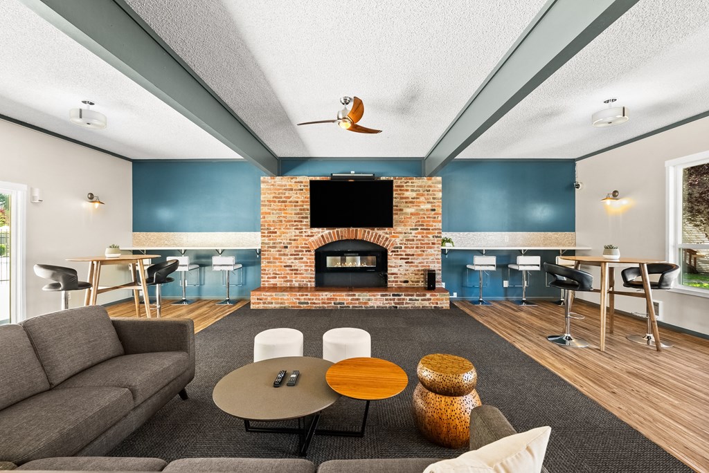a living room with a brick fireplace and a television