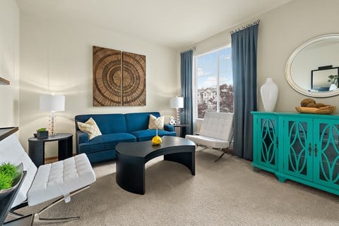 a living room with a blue couch and a black coffee table