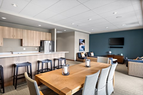 a conference room with a table and chairs and a kitchen