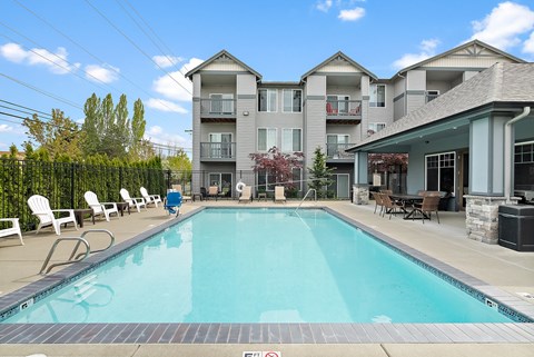 a swimming pool with a building in the background