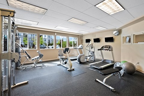 gym with exercise equipment and windows at the citizens apartments oh