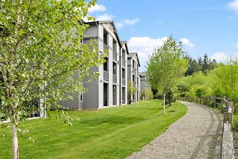 modern apartment buildings on the side of a road with trees