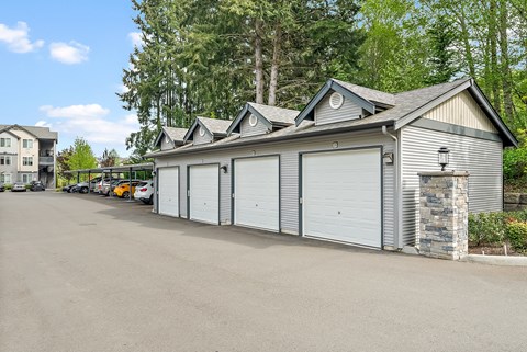 a large garage with white doors and a parking lot
