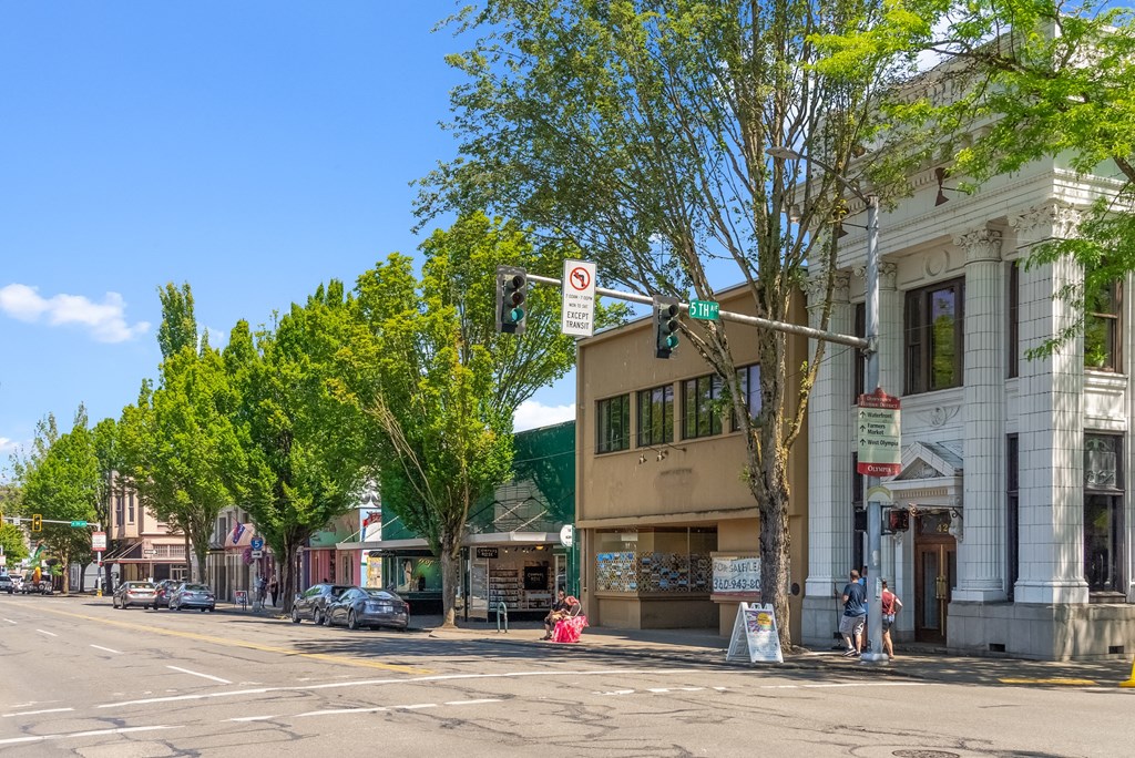 a street corner with a traffic light and a building on the corner