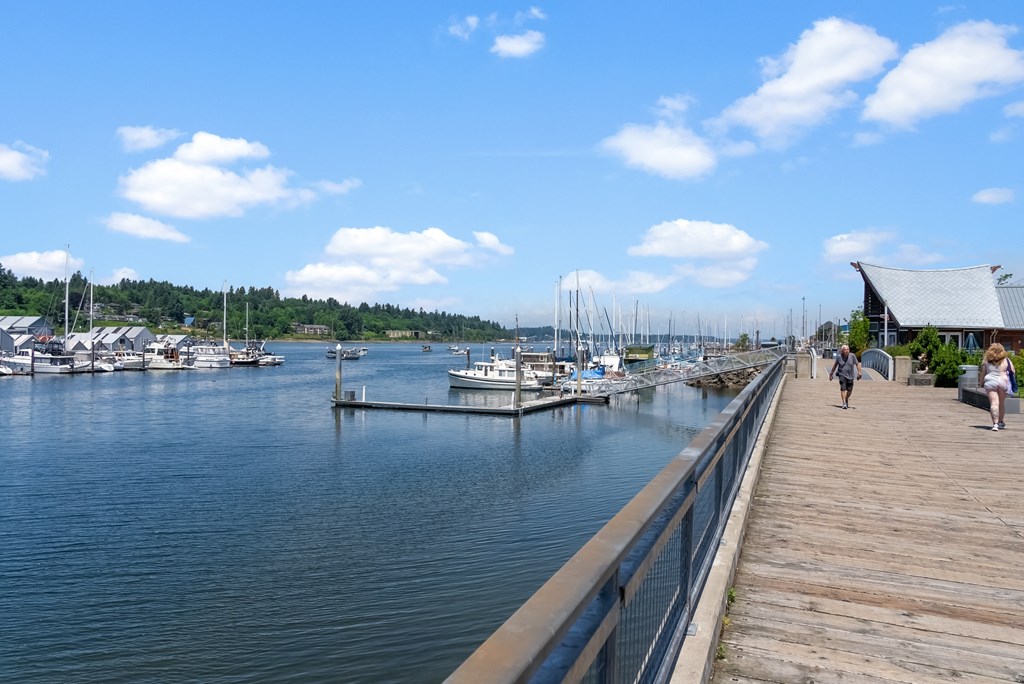 a dock on the water with boats in a marina