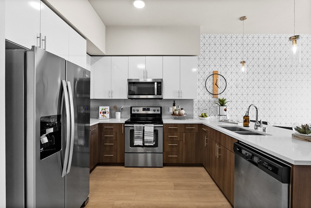 a kitchen with stainless steel appliances and white cabinets