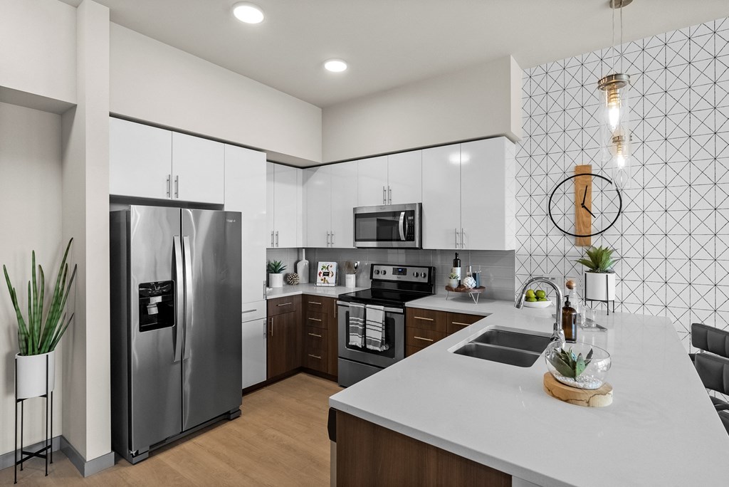 a kitchen with stainless steel appliances and a white counter top