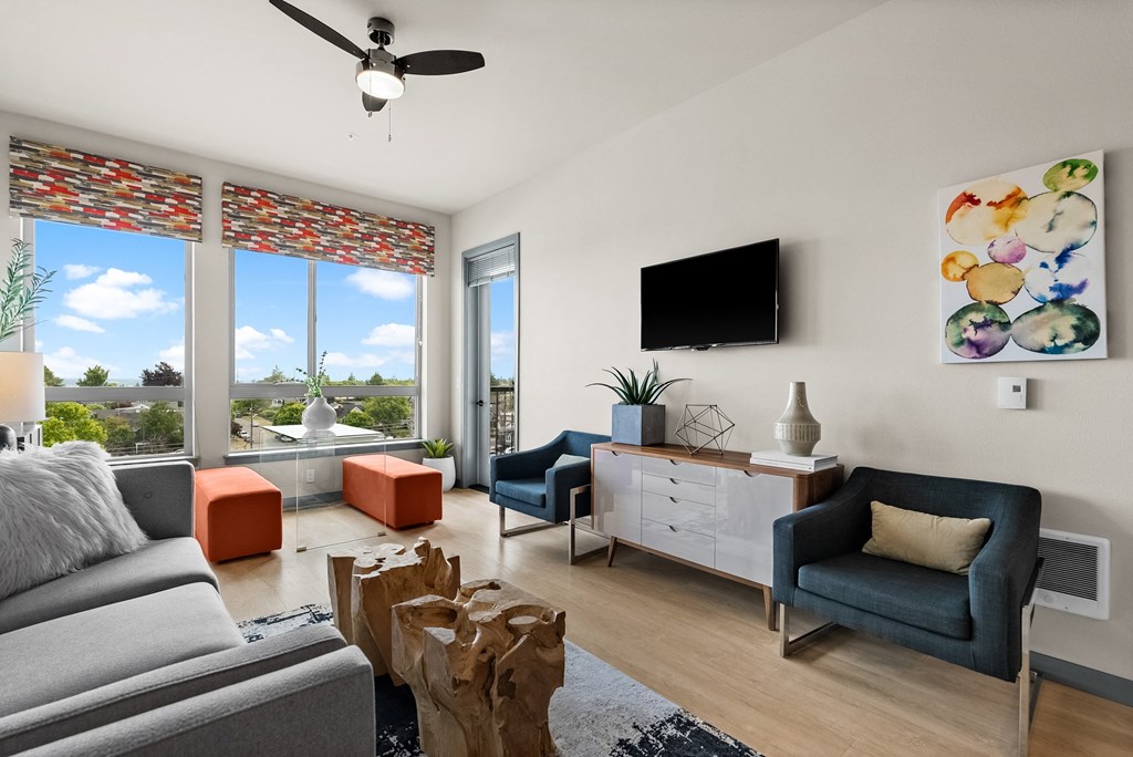 a living room with couches and chairs and a tv