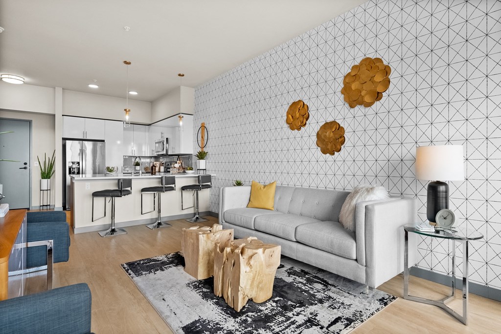 a living room with a couch and a kitchen in the background