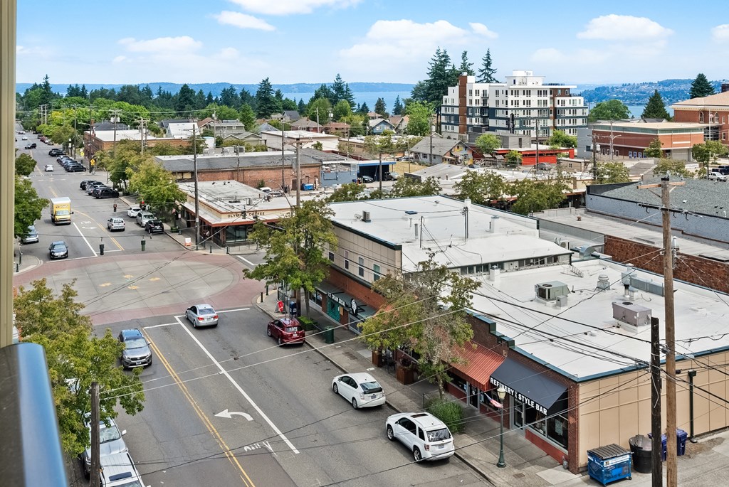 an aerial view of a city street with cars and buildings
