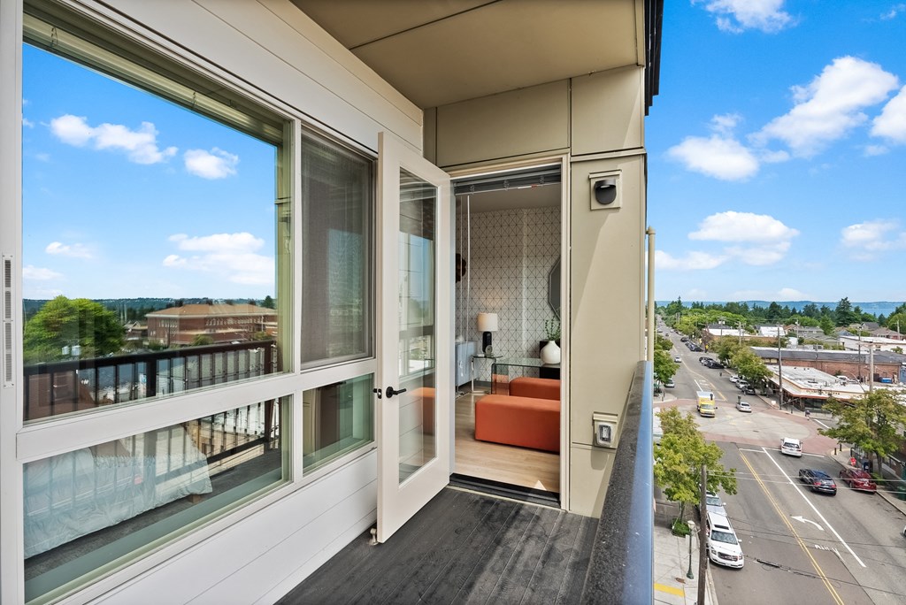 a room with a view of a city from a balcony