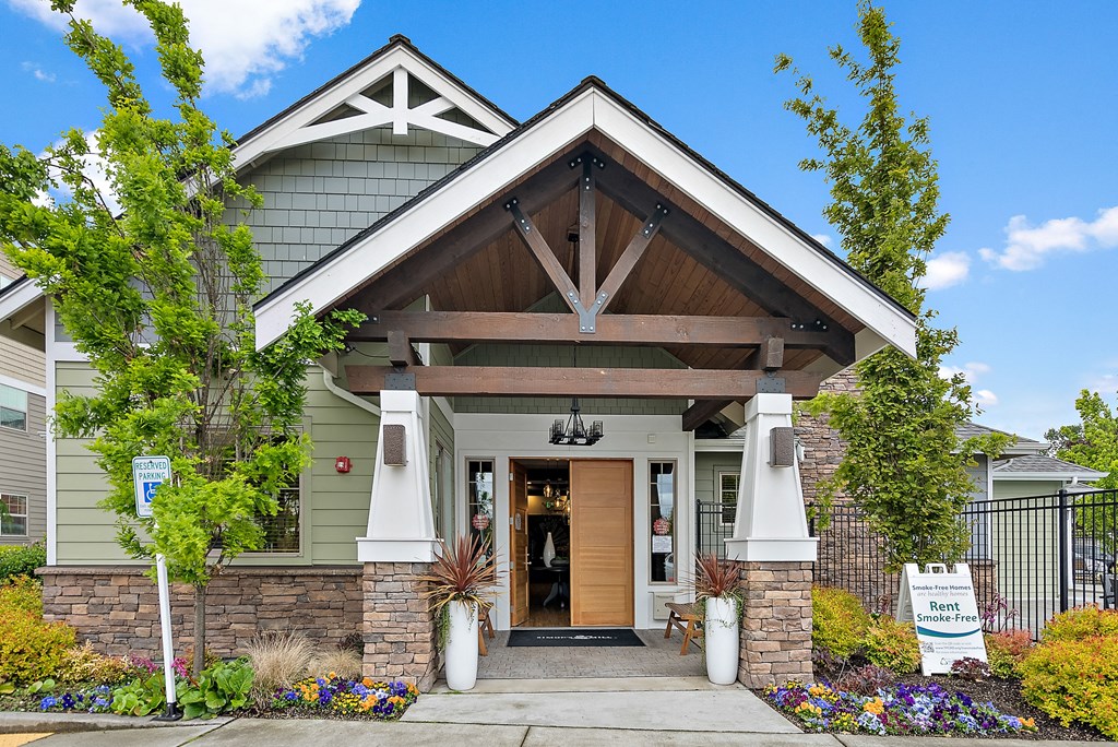 the front entrance of a building with a porch and a door