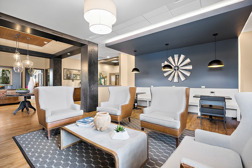 a living room with blue walls and white furniture