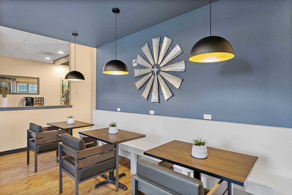 a dining room with tables and chairs and a clock on the wall