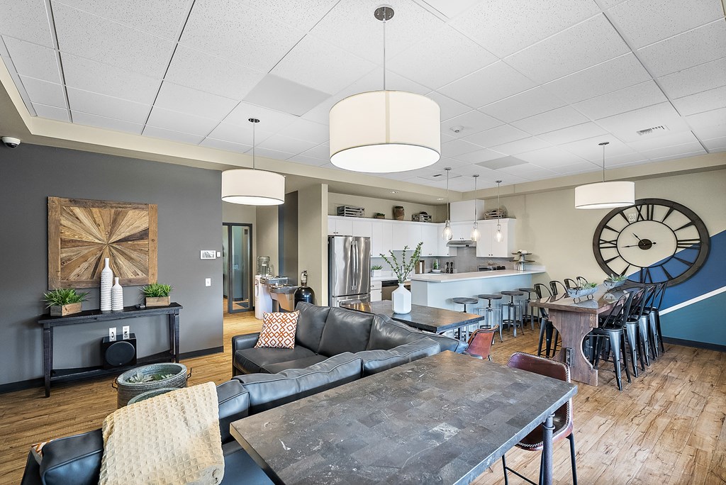 a living room and dining room with a large clock on the wall