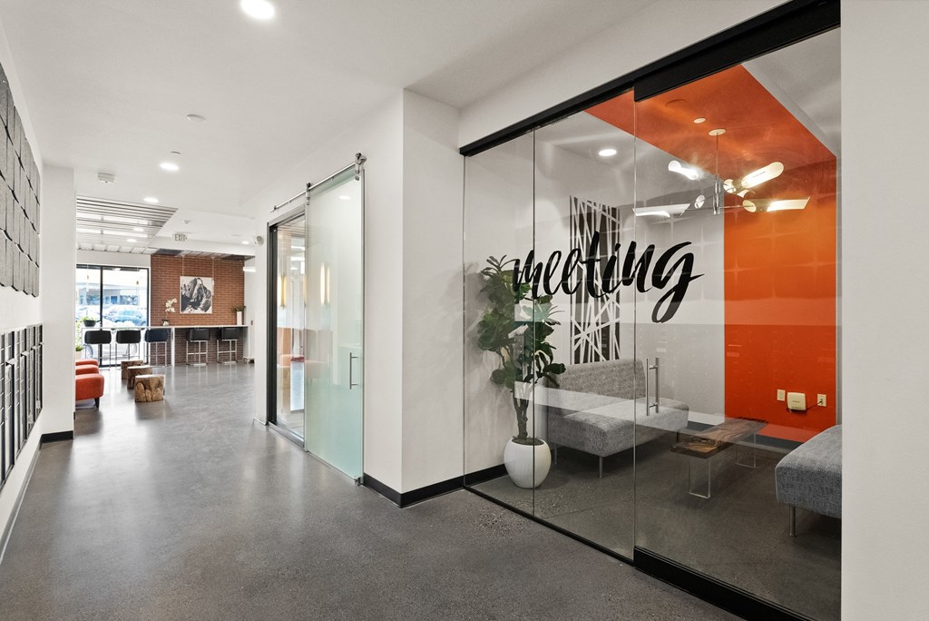 an office with a glass wall with a sign that reads auditing