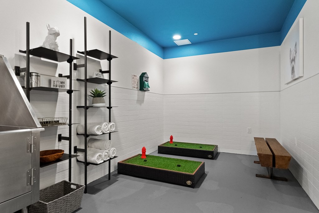 a game room with two mini golf courses and a shelving system
