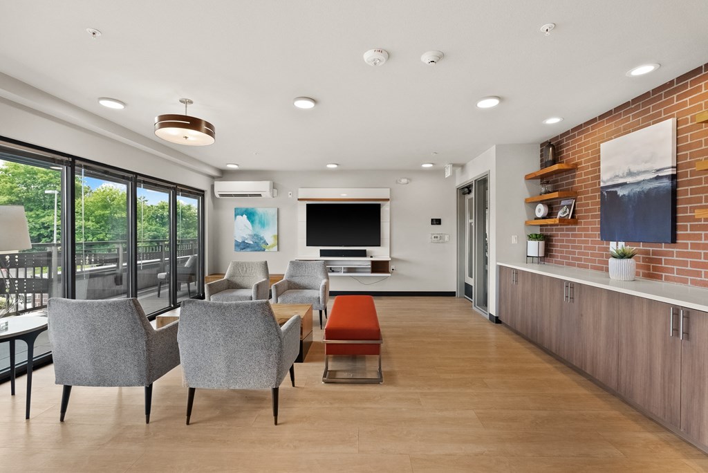 a living room with chairs and a table and a television