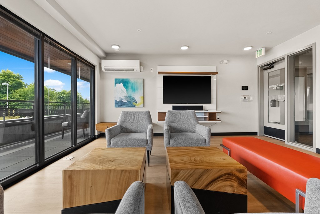 a living room with a table and chairs and a television