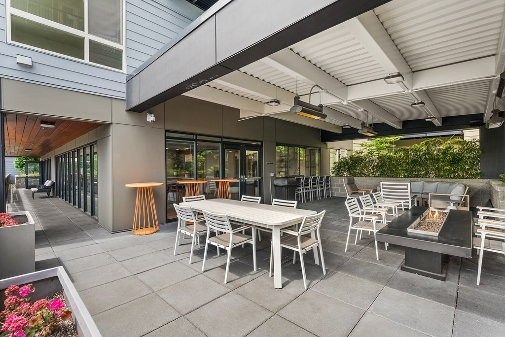 a patio with tables and chairs outside of a building
