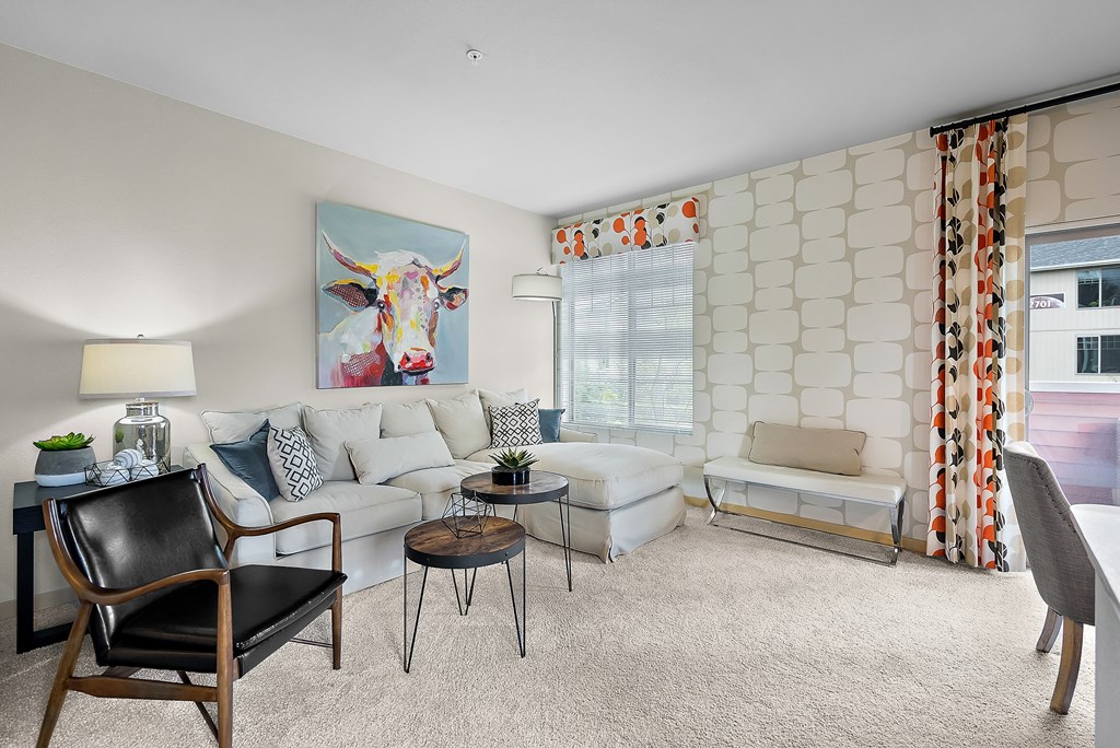 an open living room with a white couch and a table
